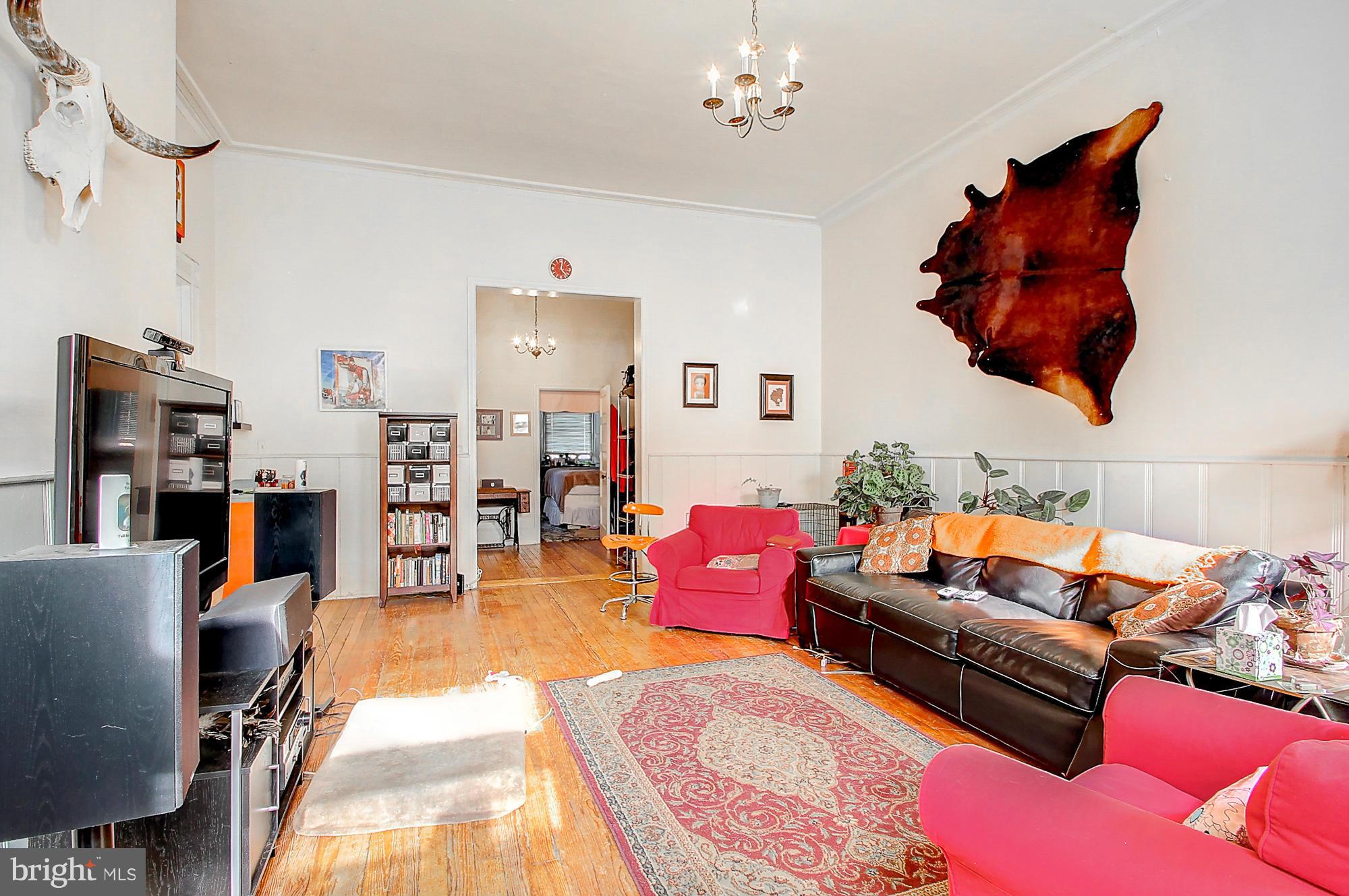18 West Franklin Street Baltimore, MD 21201 - Photo 15 of 30 a living room with furniture a rug and a chandelier