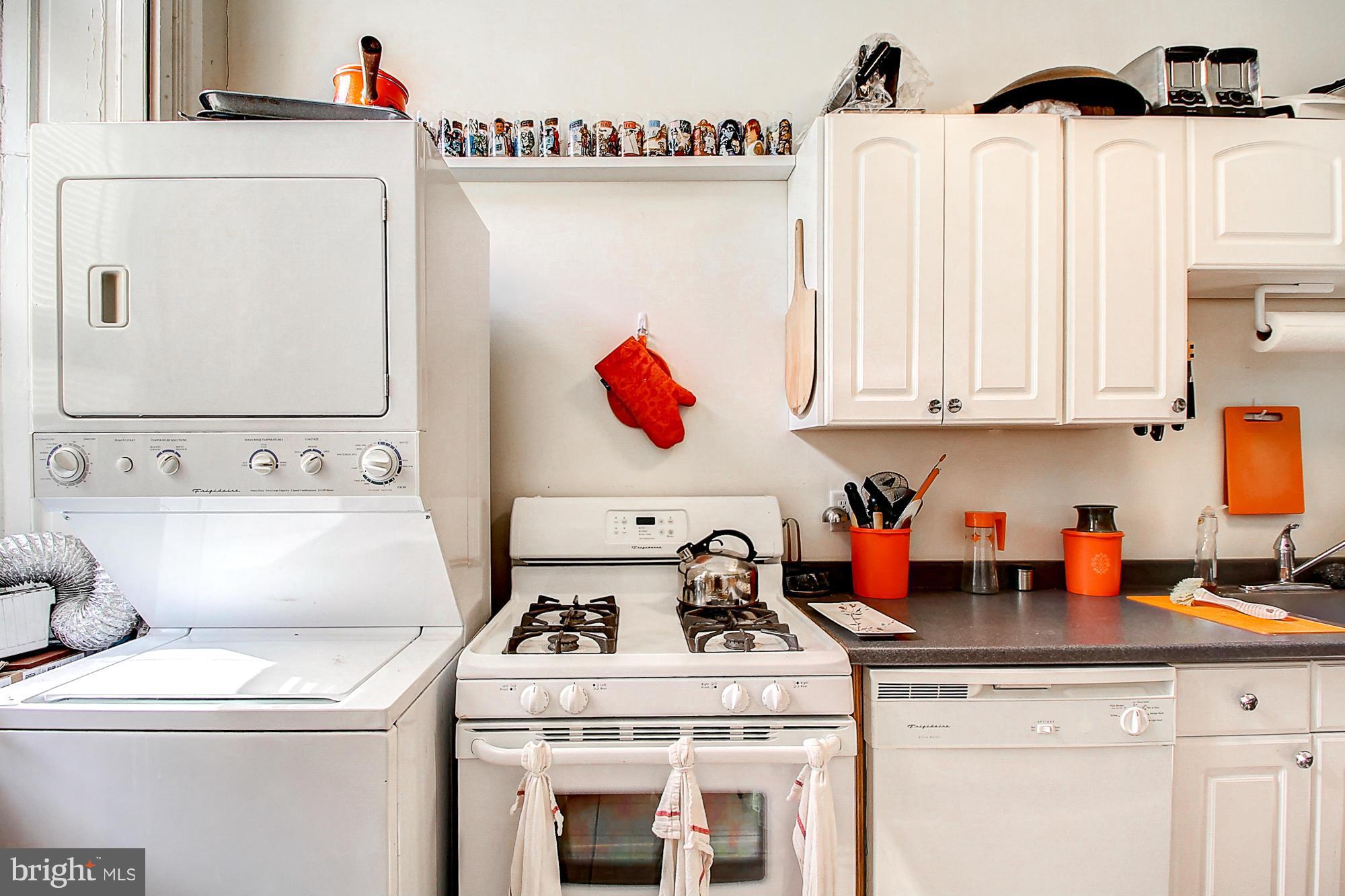 18 West Franklin Street Baltimore, MD 21201 - Photo 17 of 30 a kitchen with a stove and white cabinets