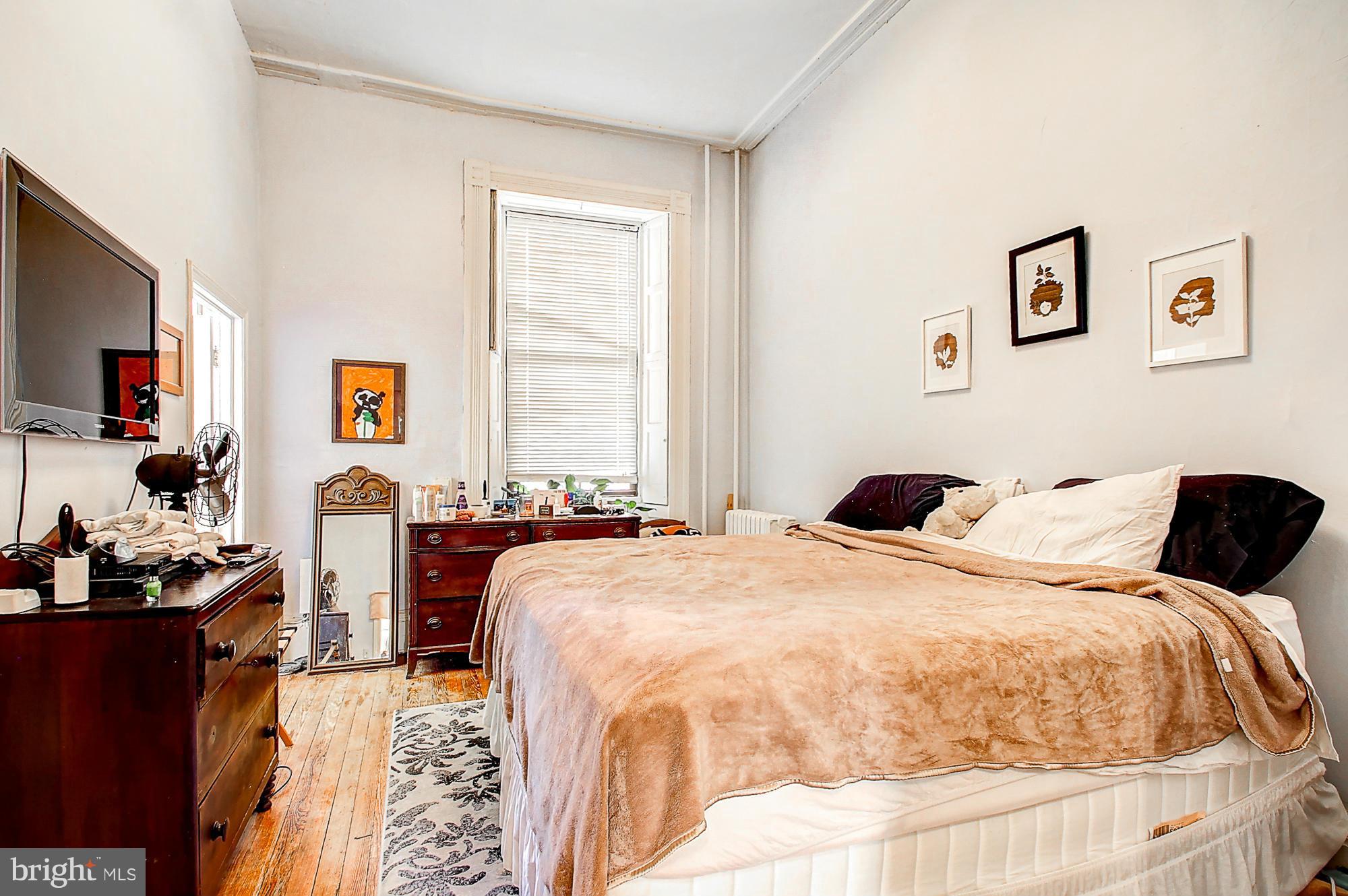 18 West Franklin Street Baltimore, MD 21201 - Photo 19 of 30 a bedroom with a bed and glass windows