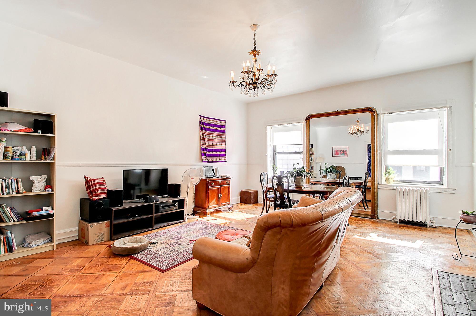 18 West Franklin Street Baltimore, MD 21201 - Photo 22 of 30 a living room with furniture a flat screen tv and a window