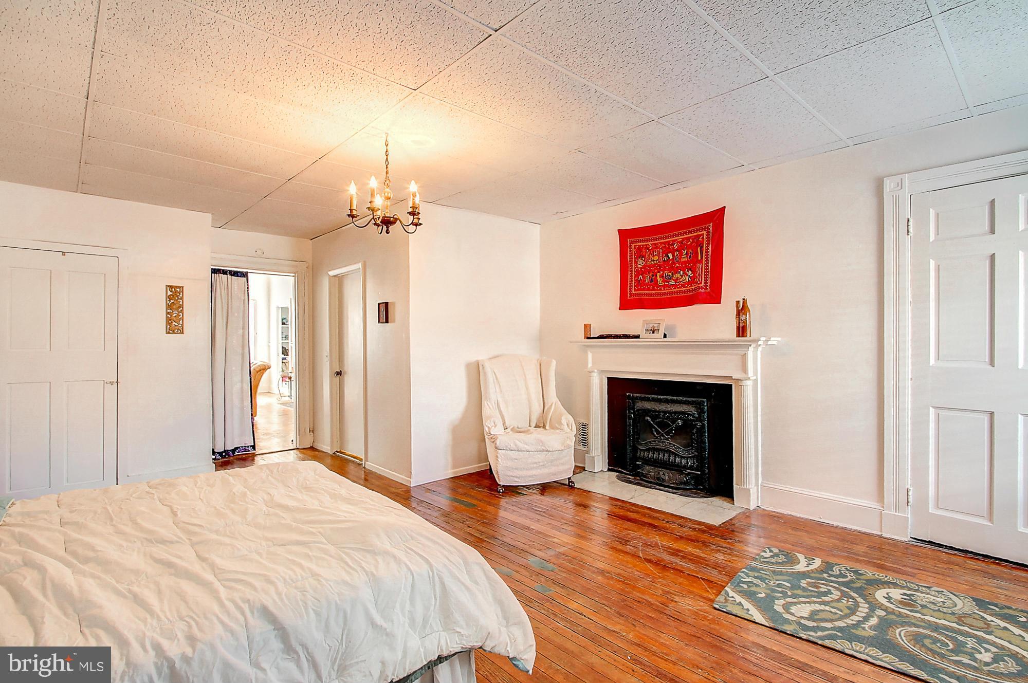 18 West Franklin Street Baltimore, MD 21201 - Photo 25 of 30 a bedroom with a bed and a fireplace