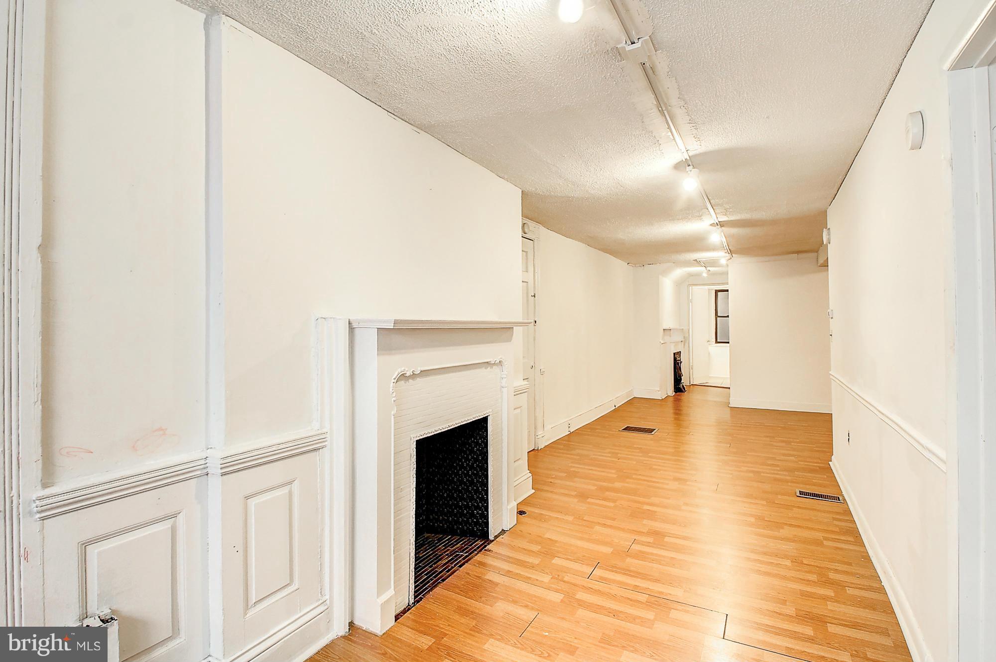 18 West Franklin Street Baltimore, MD 21201 - Photo 26 of 30 a view of an empty room with wooden floor
