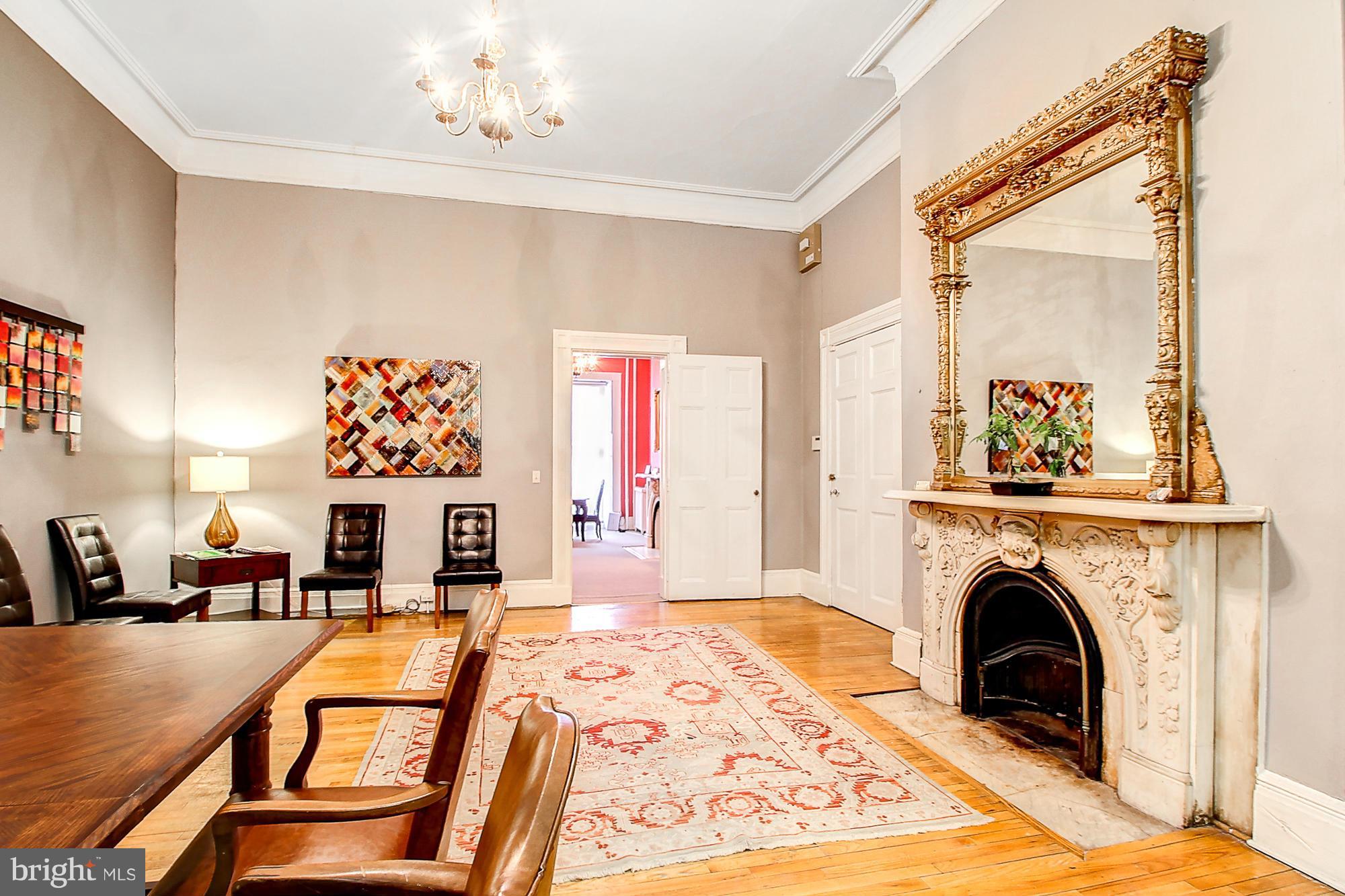18 West Franklin Street Baltimore, MD 21201 - Photo 10 of 30 a view of a livingroom with furniture a fireplace and windows