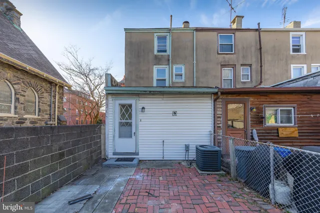 a view of a brick house with a large windows