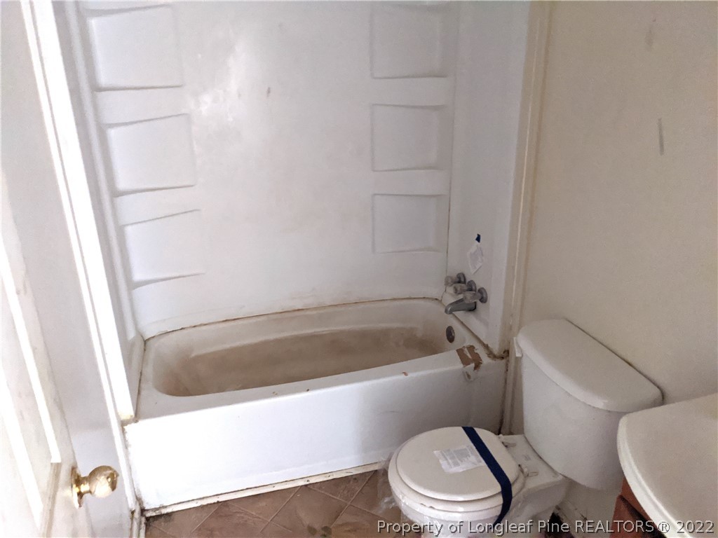 661 Azalea Drive Spring Lake, NC 28390 - Photo 5 of 7 a white toilet sitting next to a bath tub