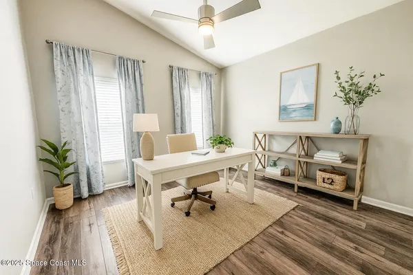 a living room with furniture and a potted plant