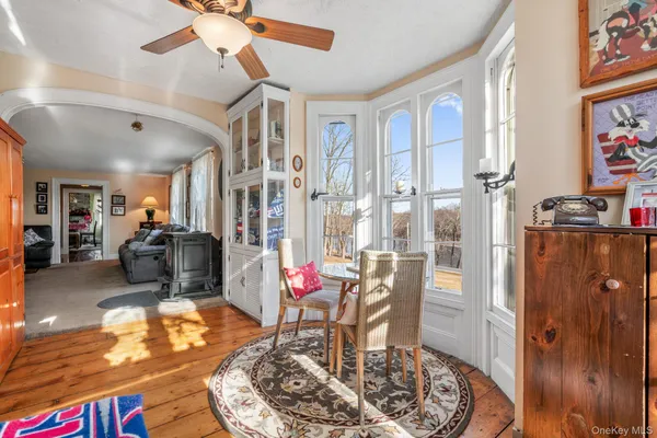 a living room with furniture a dining table and a chandelier
