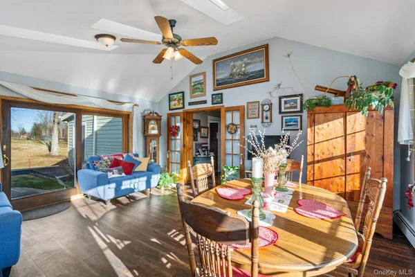 a living room with lots of furniture and a large window