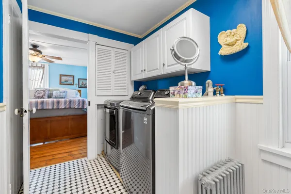 a room with a washing machine and cabinets