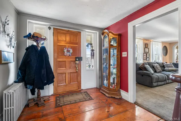 a living room with a bed and a mirror