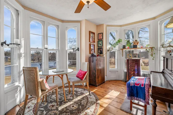 a living room with furniture and a floor to ceiling window