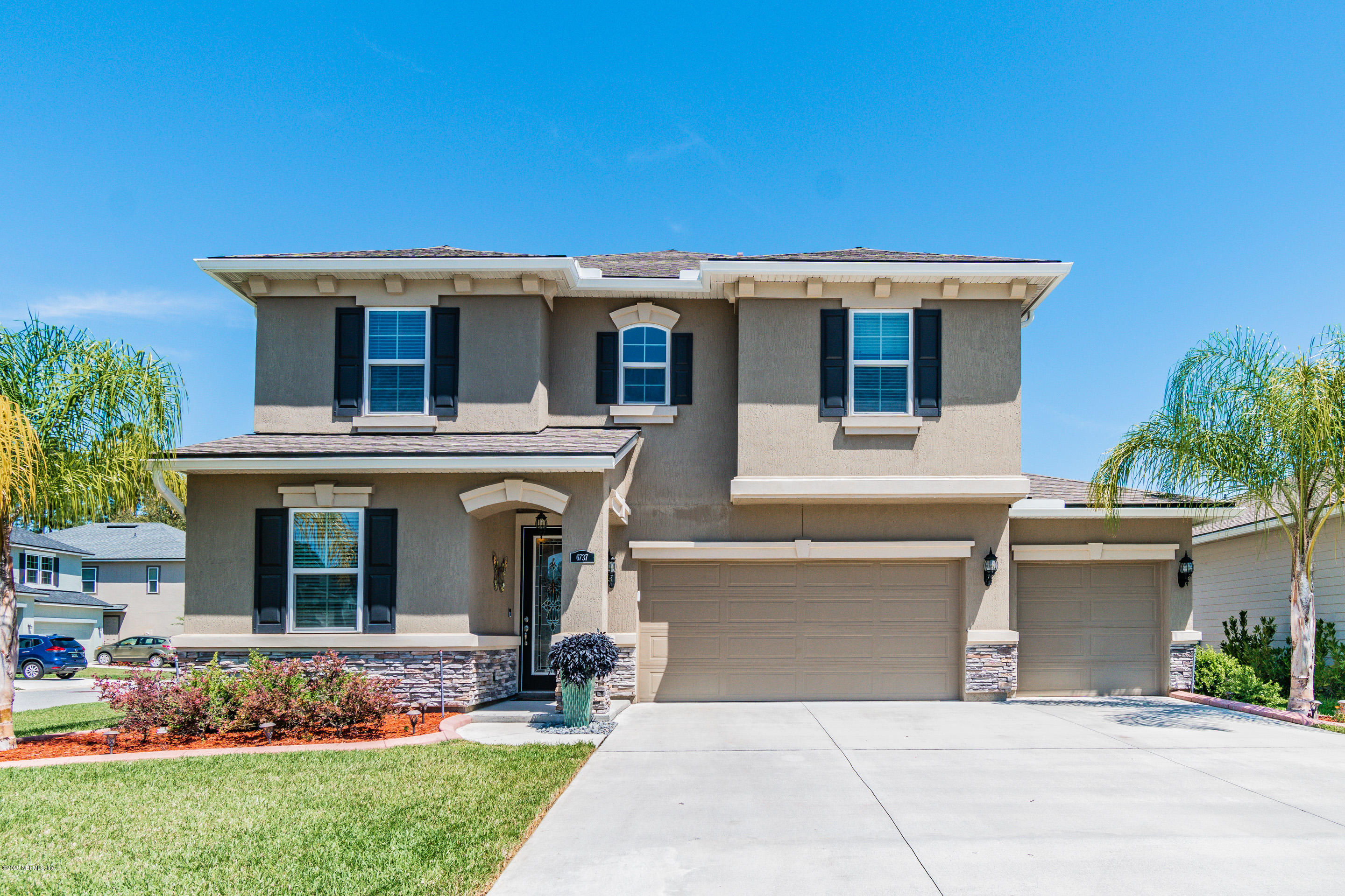 6737 Discovery Crossing Road Jacksonville, FL 32259 - Photo 1 of 51 a front view of a house with garden