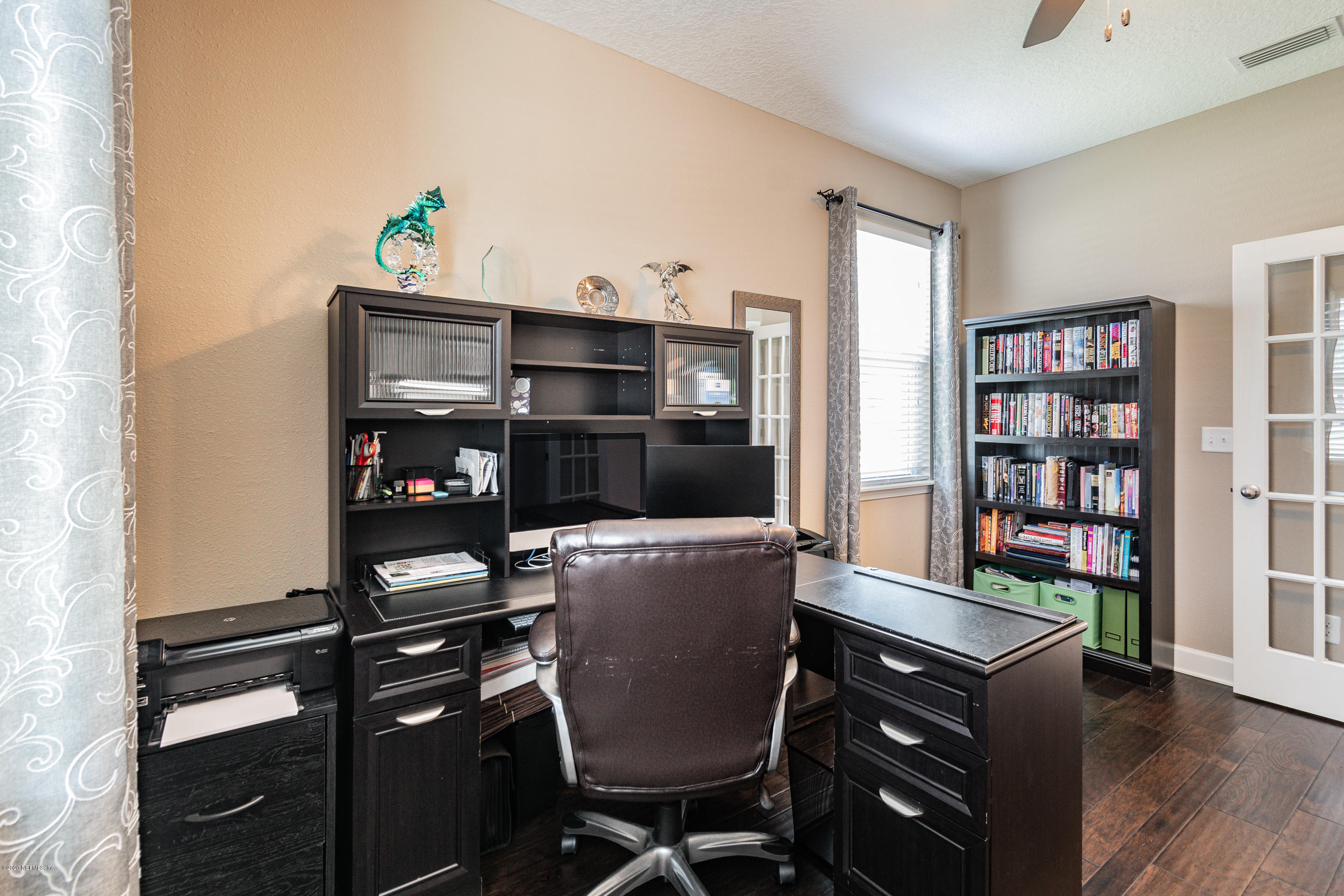 6737 Discovery Crossing Road Jacksonville, FL 32259 - Photo 14 of 51 a living room with furniture and a book shelf
