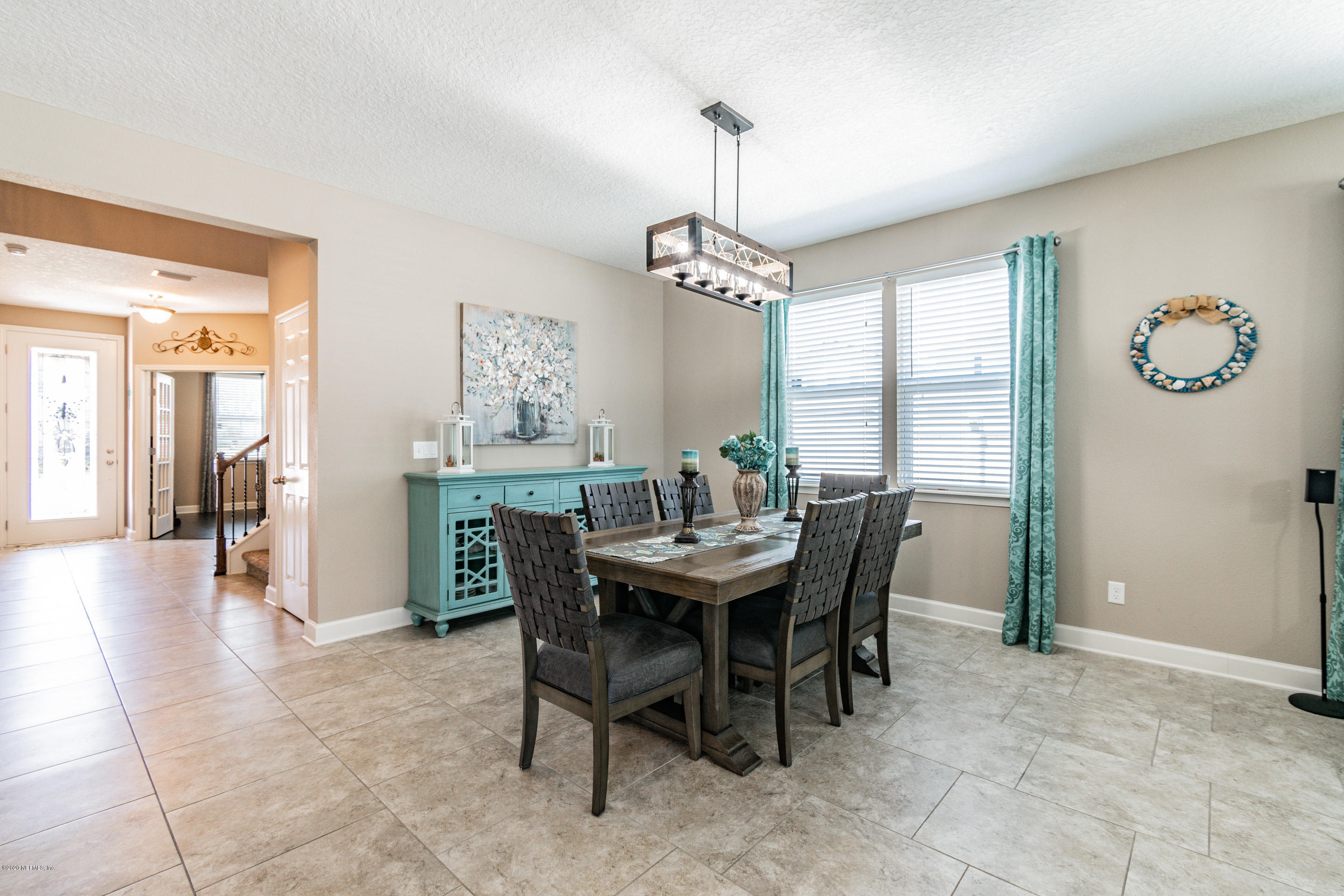 6737 Discovery Crossing Road Jacksonville, FL 32259 - Photo 19 of 51 a view of a dining room with furniture window and wooden floor