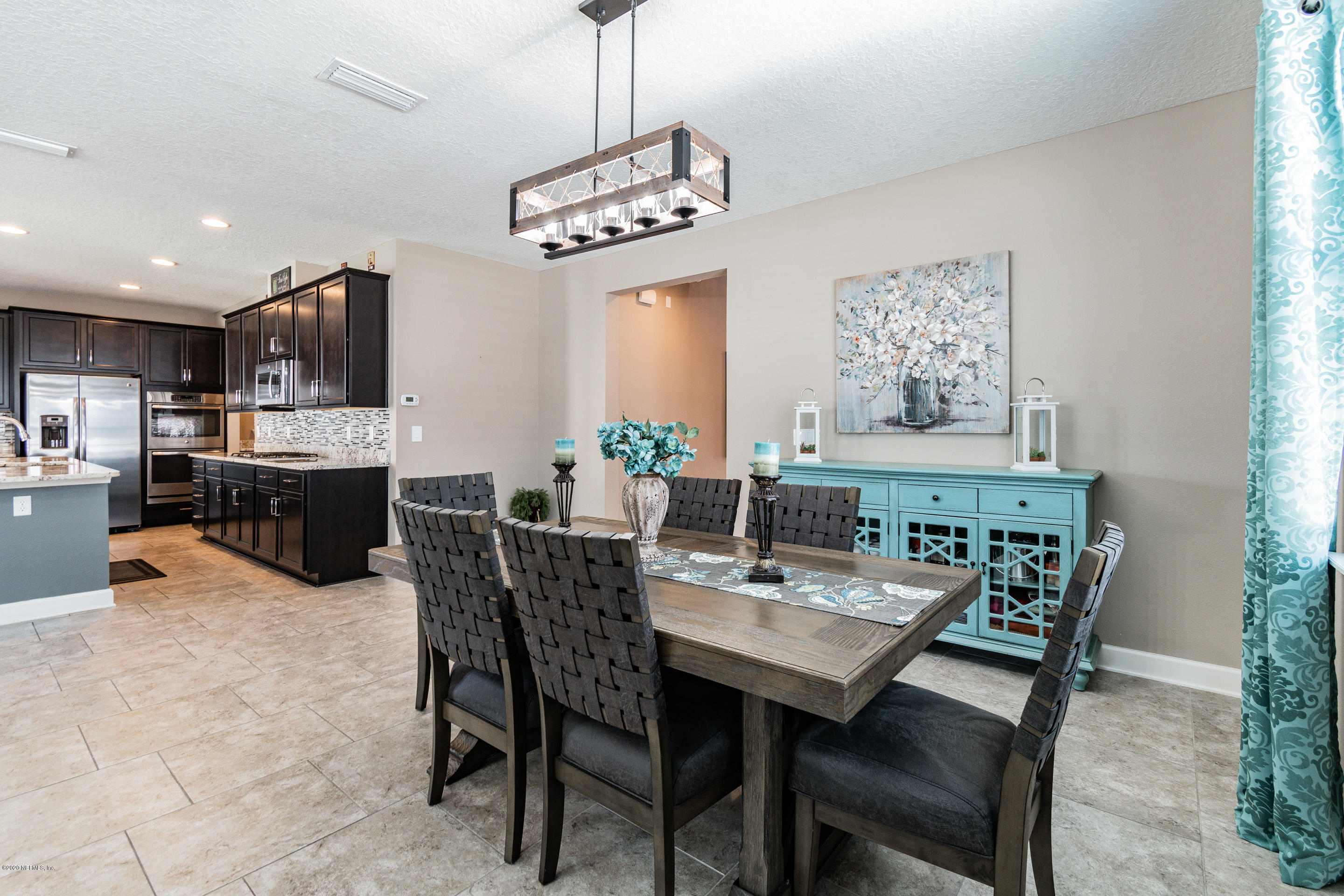 6737 Discovery Crossing Road Jacksonville, FL 32259 - Photo 20 of 51 a view of a dining room with furniture and a chandelier