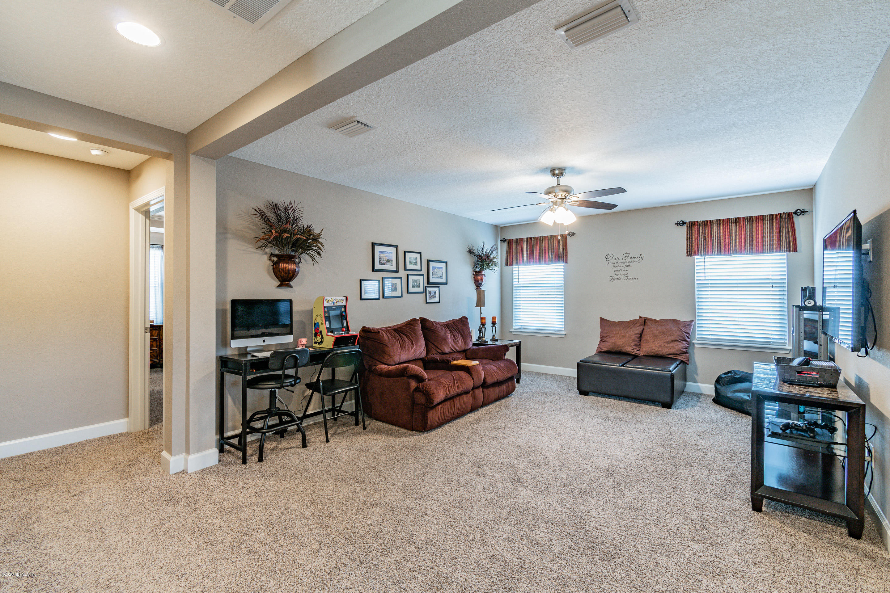 6737 Discovery Crossing Road Jacksonville, FL 32259 - Photo 24 of 51 a living room with furniture and a chandelier