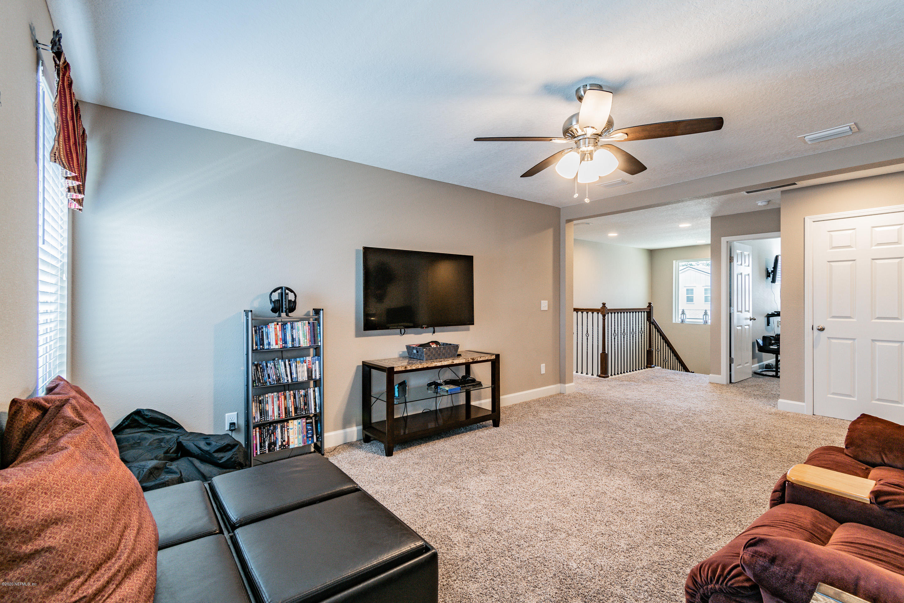 6737 Discovery Crossing Road Jacksonville, FL 32259 - Photo 26 of 51 a living room with furniture and a flat screen tv