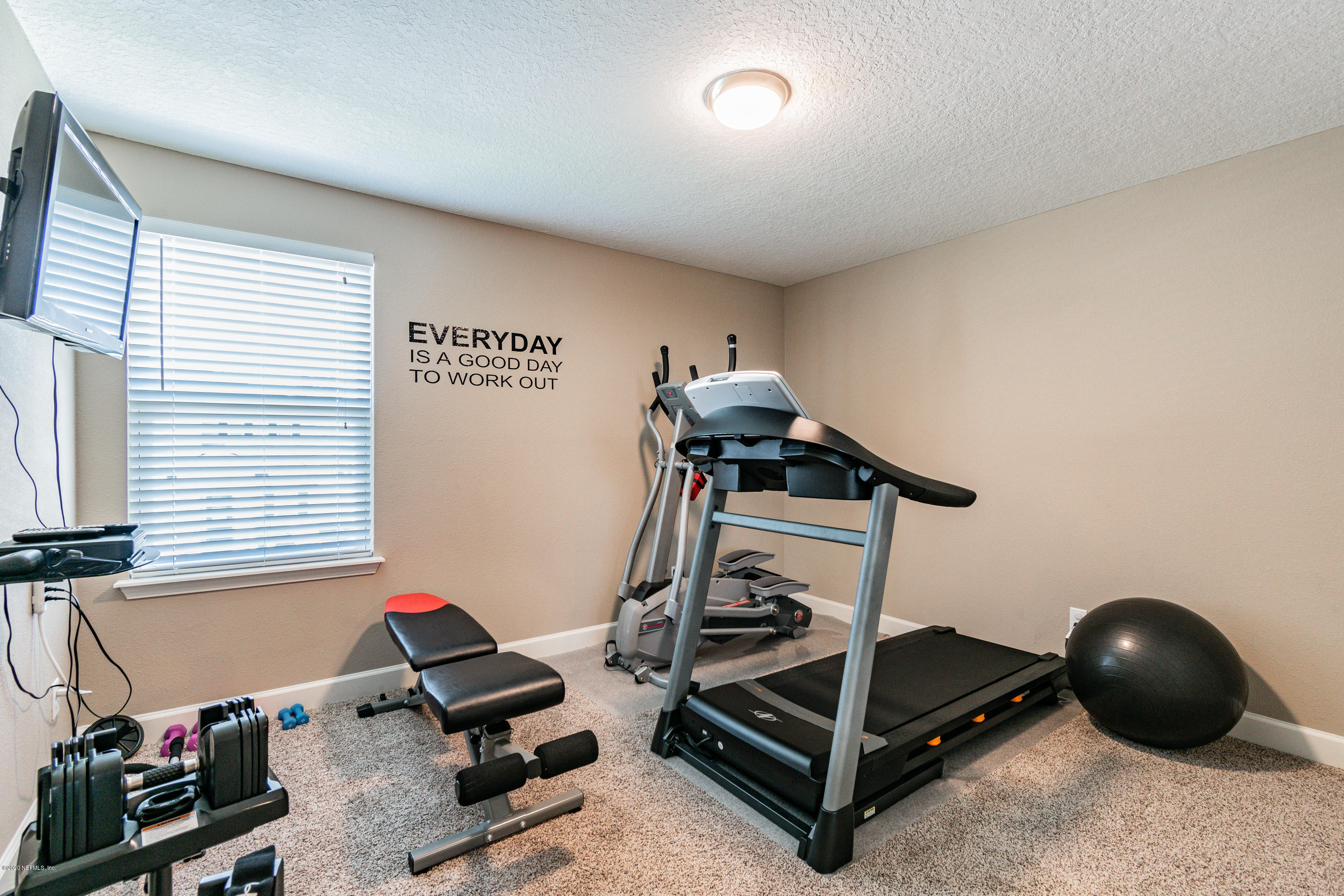 6737 Discovery Crossing Road Jacksonville, FL 32259 - Photo 27 of 51 a room with gym equipment and windows