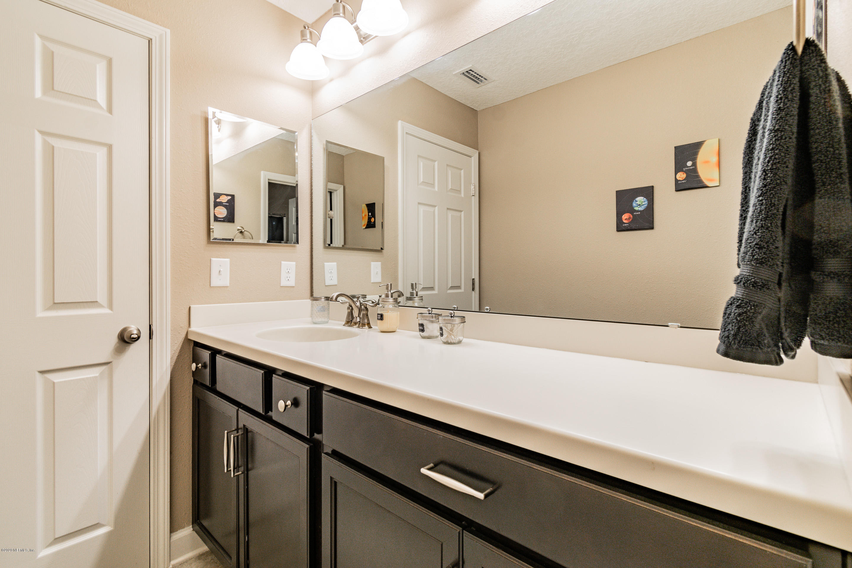6737 Discovery Crossing Road Jacksonville, FL 32259 - Photo 32 of 51 a bathroom with a sink and a mirror