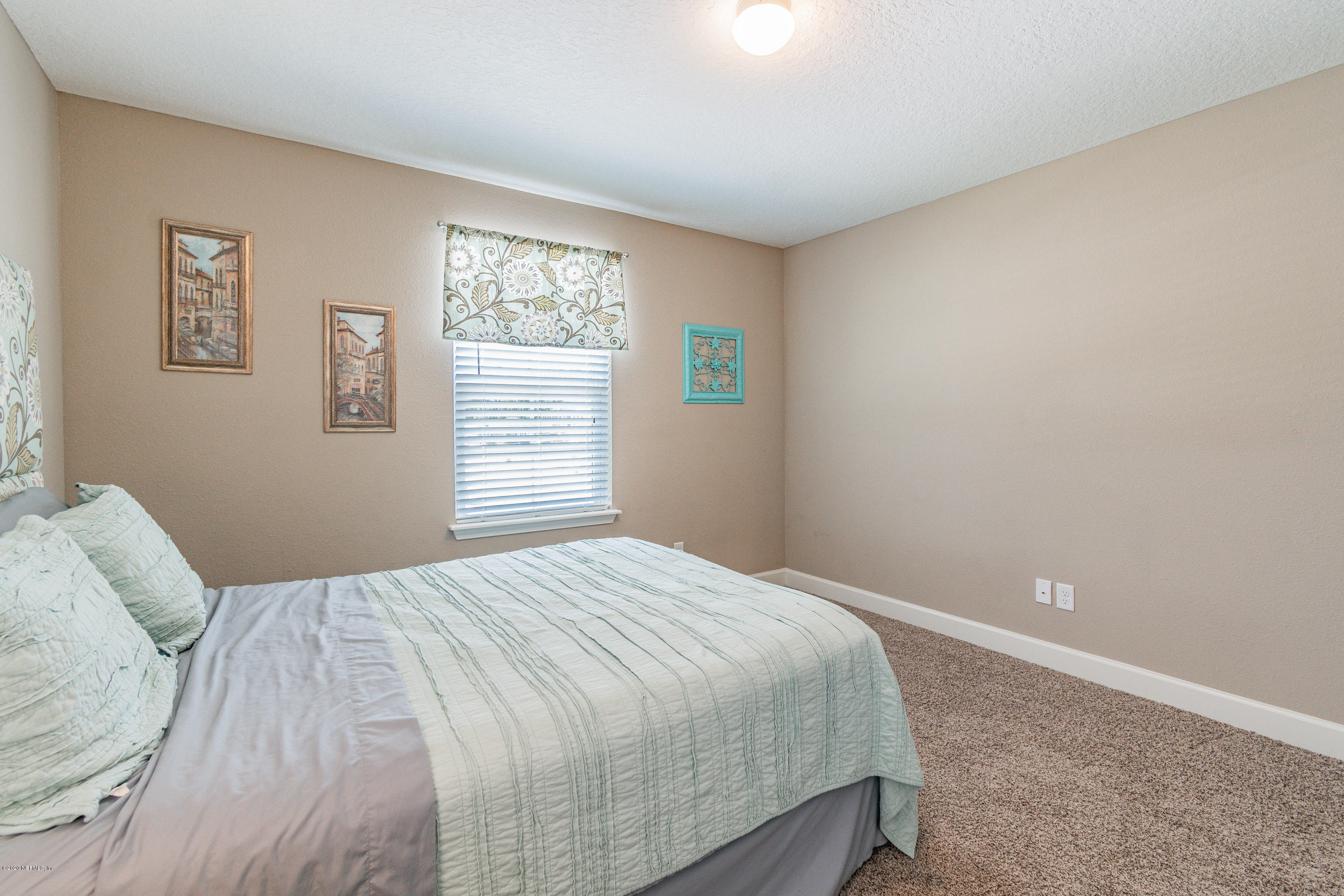 6737 Discovery Crossing Road Jacksonville, FL 32259 - Photo 35 of 51 a bedroom with a bed and a window