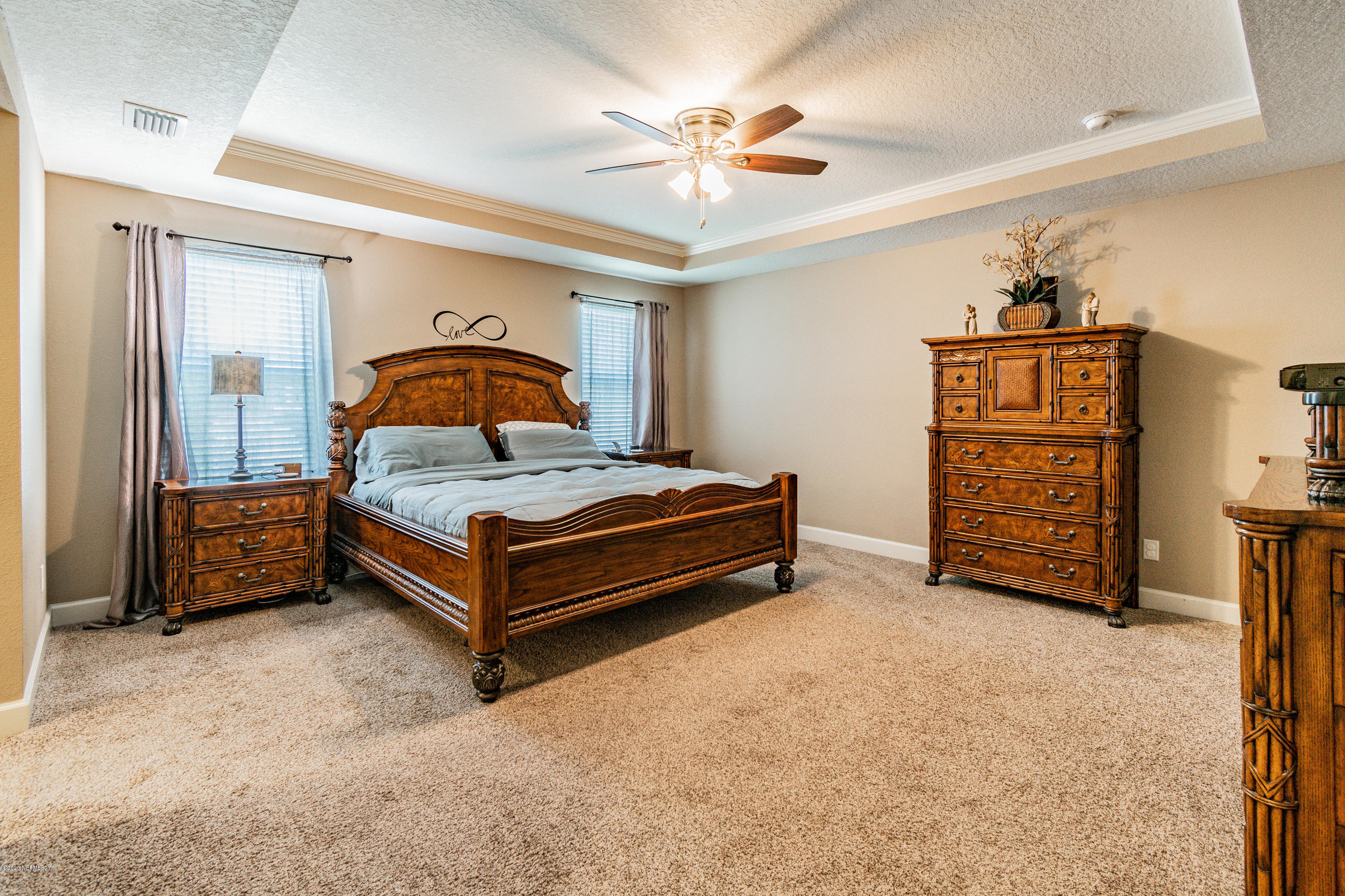 6737 Discovery Crossing Road Jacksonville, FL 32259 - Photo 38 of 51 a bedroom with a bed and a chandelier