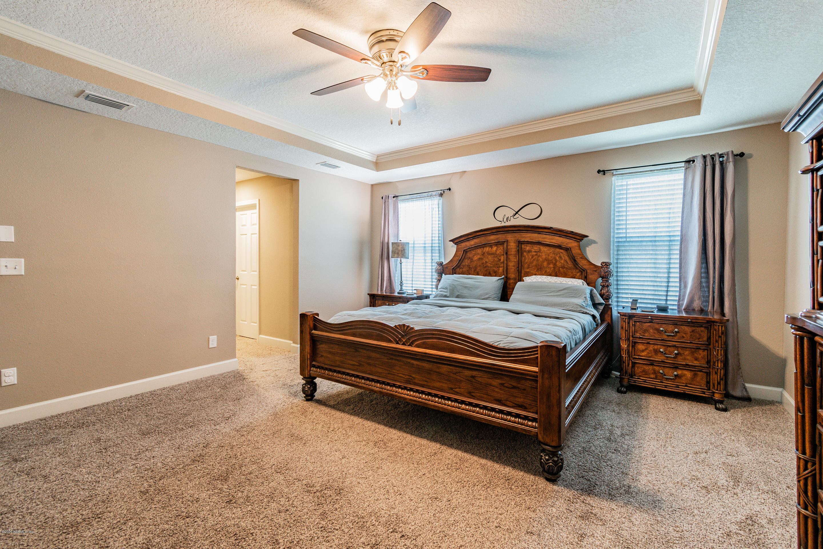 6737 Discovery Crossing Road Jacksonville, FL 32259 - Photo 39 of 51 a bedroom with a bed and a chandelier