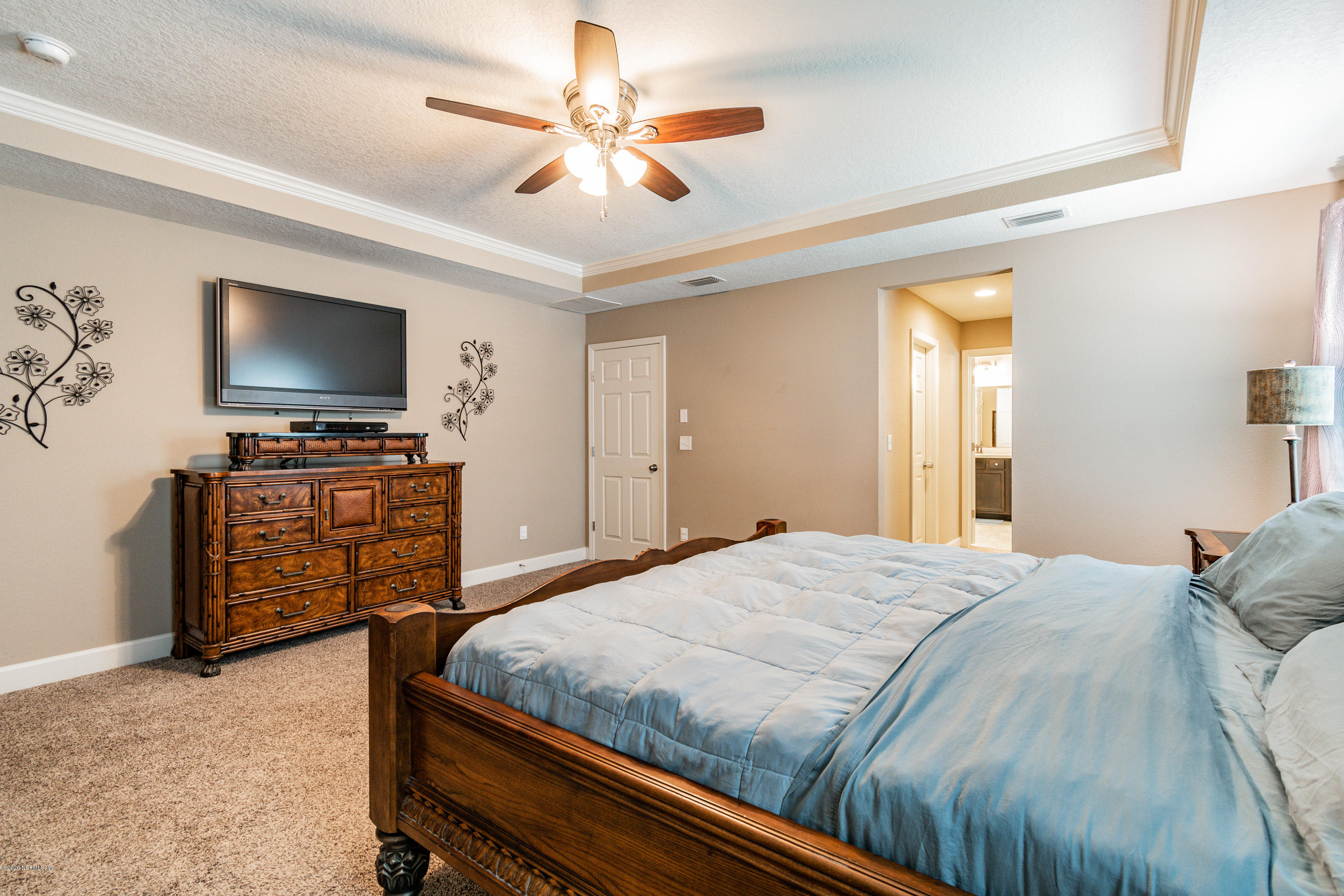 6737 Discovery Crossing Road Jacksonville, FL 32259 - Photo 40 of 51 a bedroom with a bed and a flat screen tv