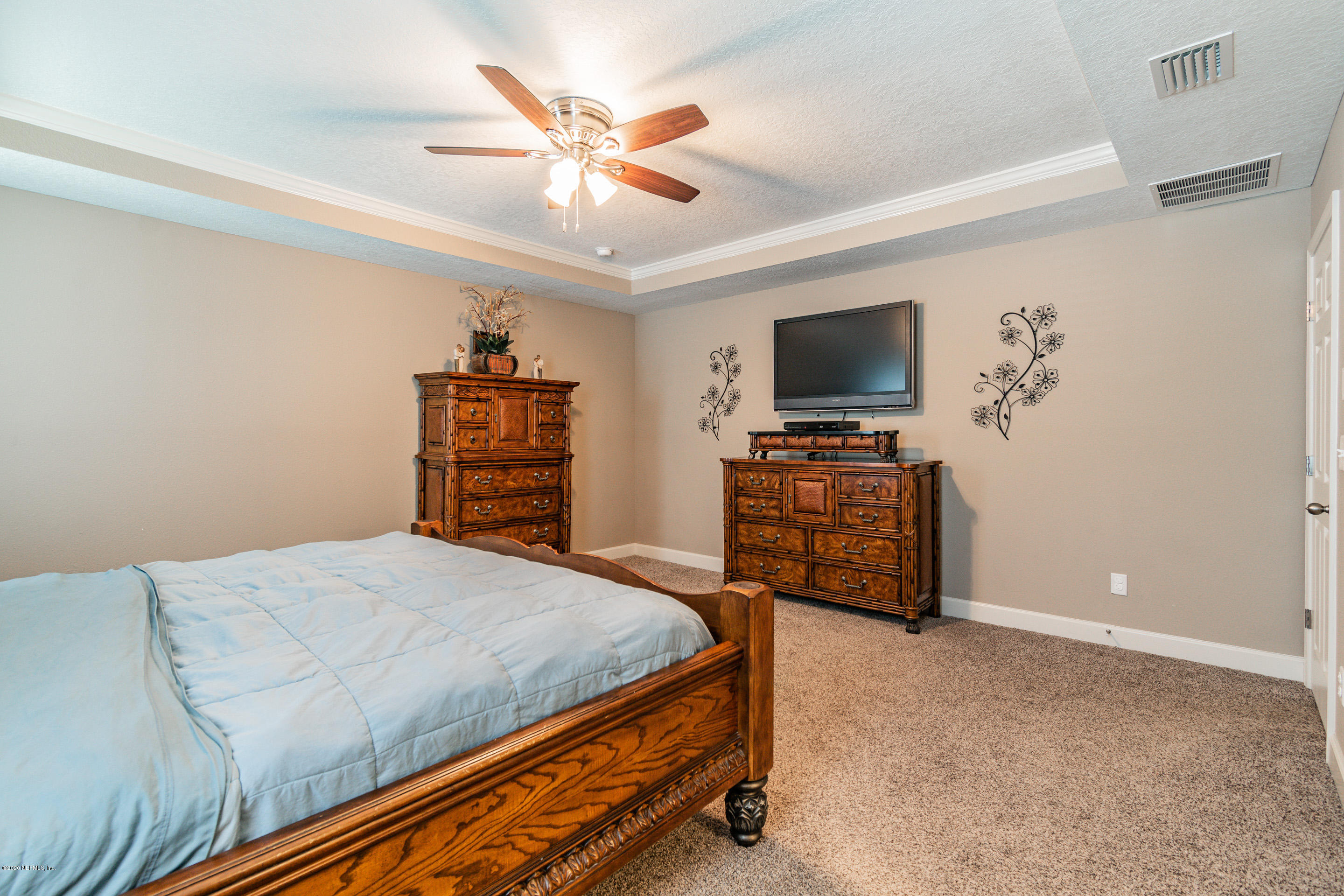 6737 Discovery Crossing Road Jacksonville, FL 32259 - Photo 41 of 51 a bedroom with a bed and a flat screen tv