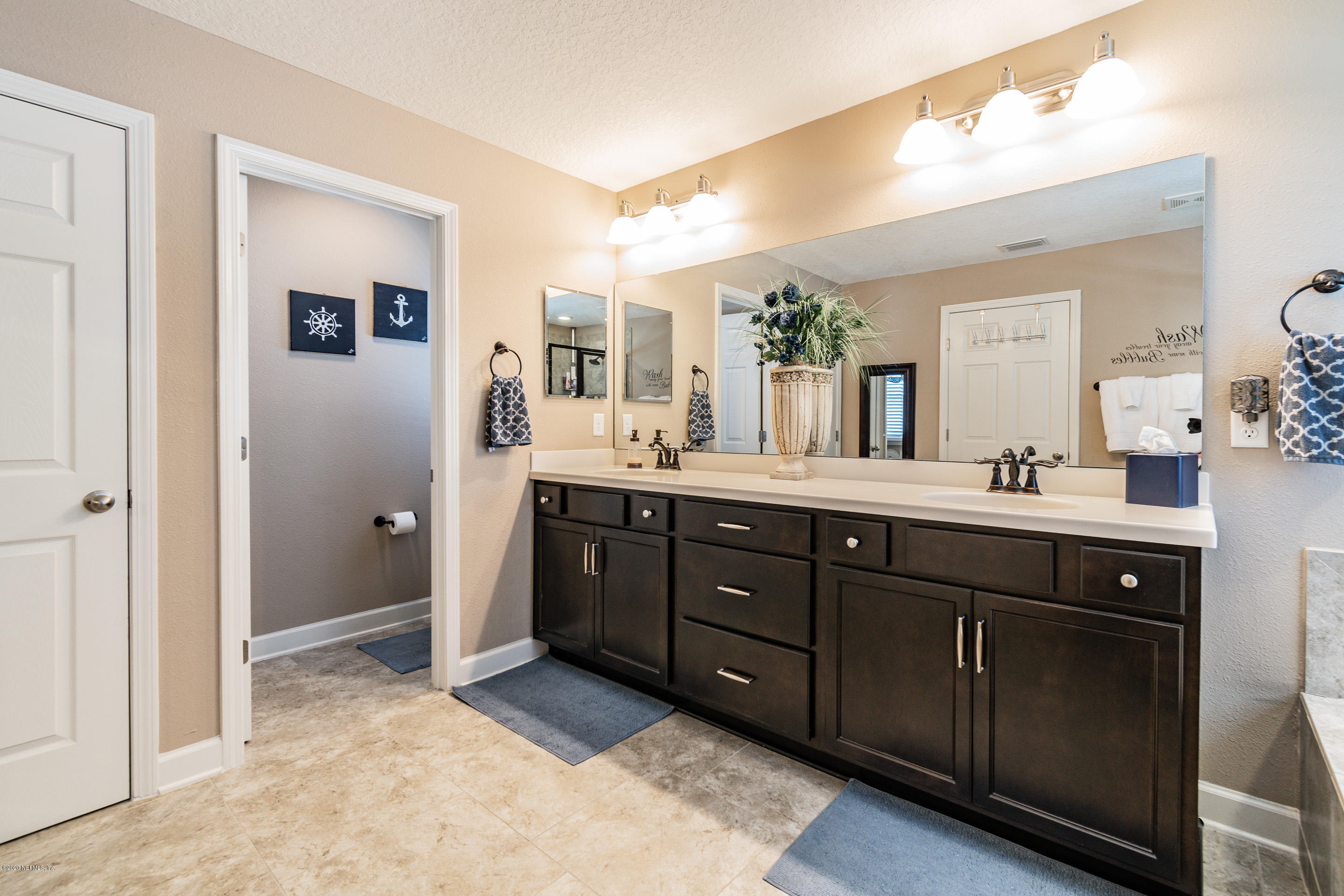6737 Discovery Crossing Road Jacksonville, FL 32259 - Photo 42 of 51 a spacious bathroom with a double vanity sink and a mirror