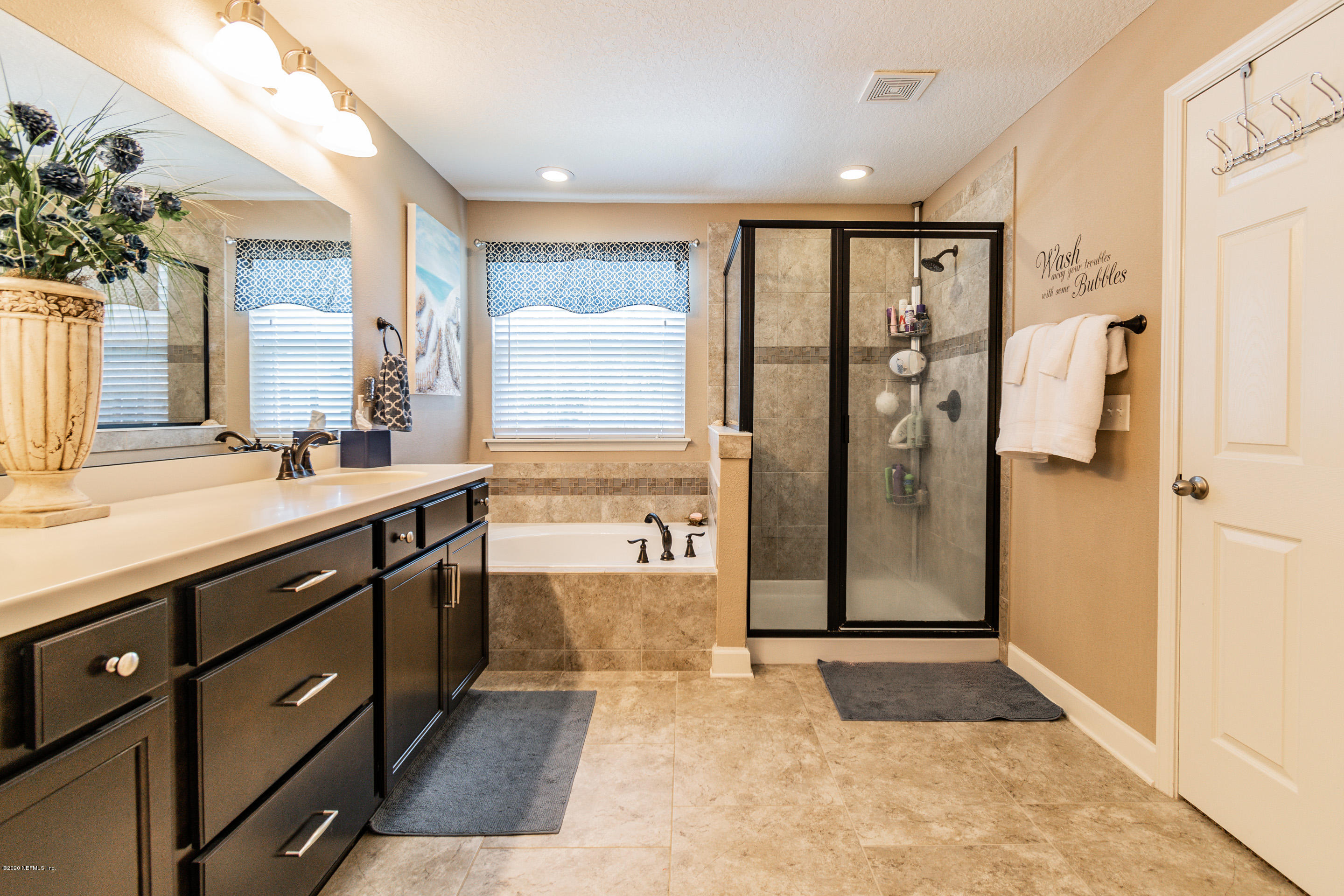 6737 Discovery Crossing Road Jacksonville, FL 32259 - Photo 44 of 51 a spacious bathroom with a shower sink and mirror