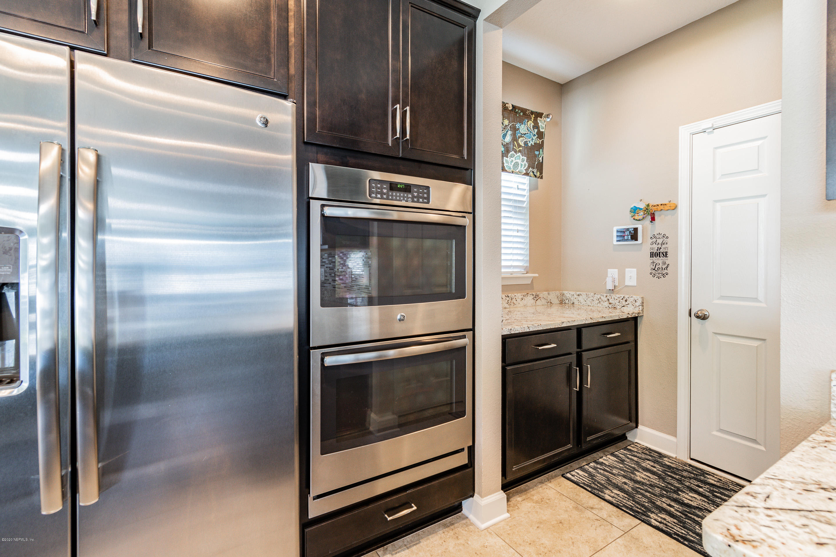 6737 Discovery Crossing Road Jacksonville, FL 32259 - Photo 7 of 51 a kitchen with granite countertop stainless steel appliances and wooden cabinets