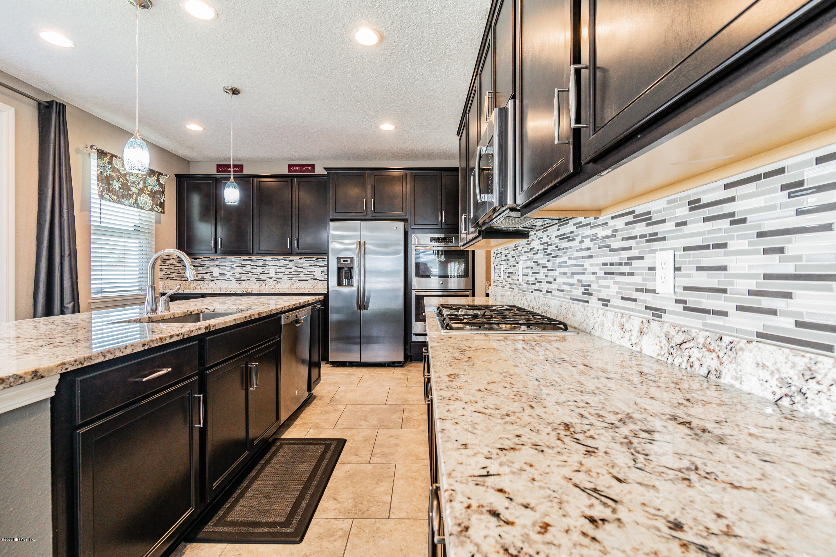 6737 Discovery Crossing Road Jacksonville, FL 32259 - Photo 10 of 51 a large kitchen with a large counter top stainless steel appliances and cabinets