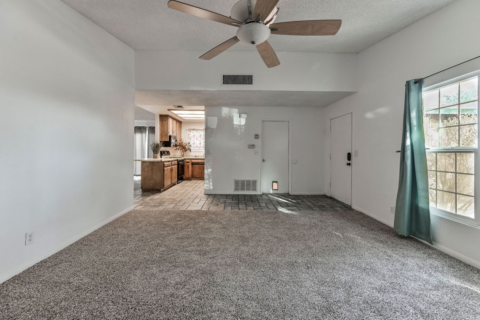 932 West St George Avenue Ridgecrest, CA 93555 - Photo 9 of 28 an empty room with chandelier fan and windows
