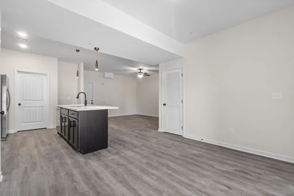 a view of a room with wooden floor and white walls