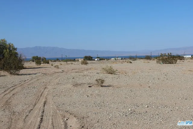 a view of ocean beach and mountain