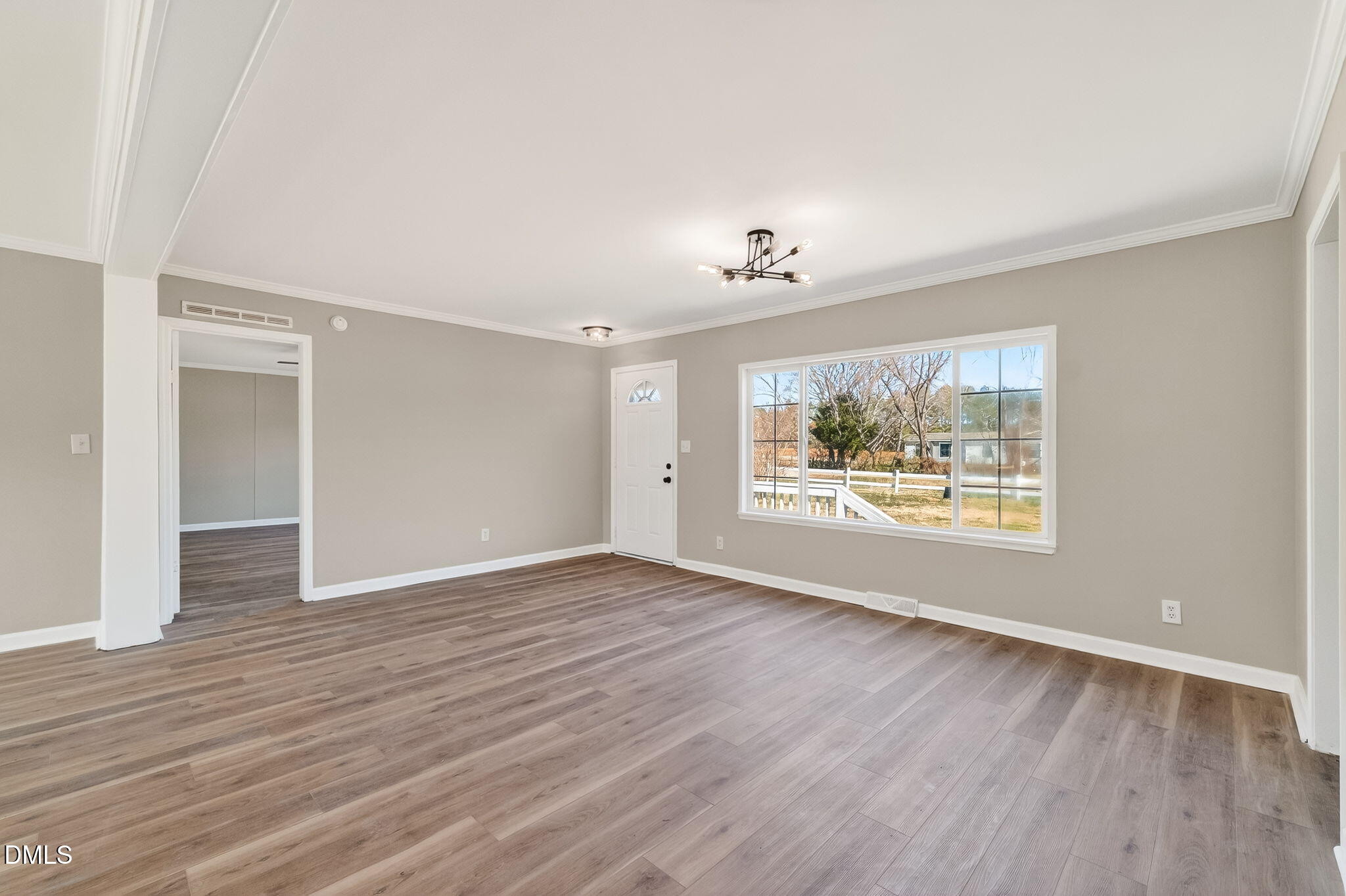 10015 Smith Road Middlesex, NC 27557 - Photo 9 of 48 a view of an empty room with a window and wooden floor