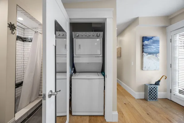 a hallway with sliding door and wooden floor
