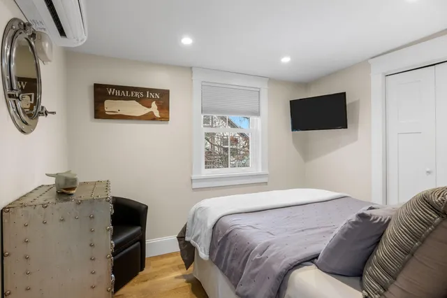 a bedroom with a bed and a television