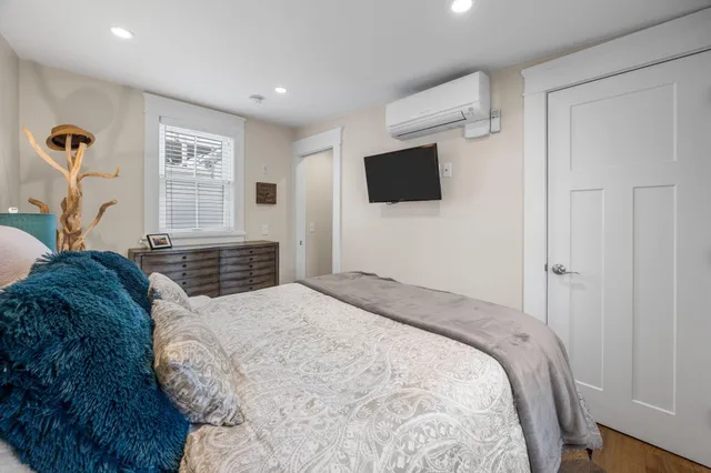 a bedroom with a large bed and a flat screen tv