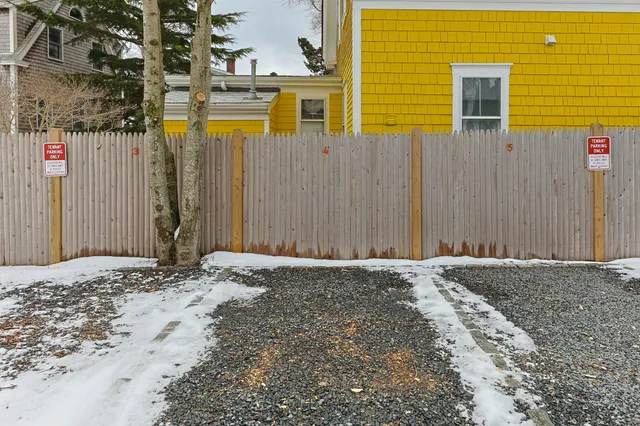 an aerial view of multiple houses with a yard