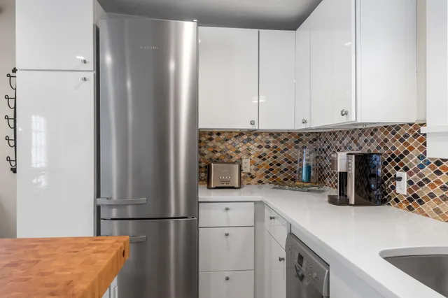 a kitchen with a refrigerator and a sink