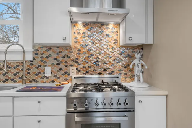 a stove top oven sitting inside of a kitchen
