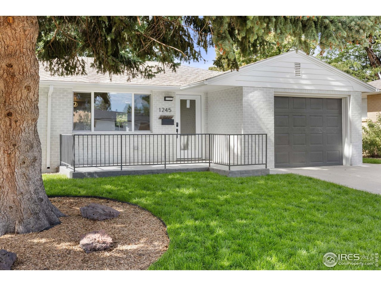 1245 Sumner Street Longmont, CO 80501 - Photo 2 of 25 a view of a house with a yard and pathway
