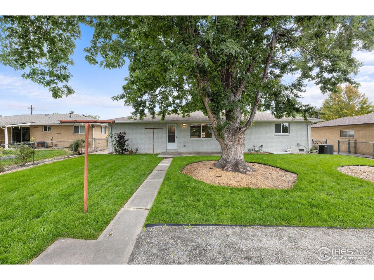 1245 Sumner Street Longmont, CO 80501 - Photo 21 of 25 a front view of a house with a yard