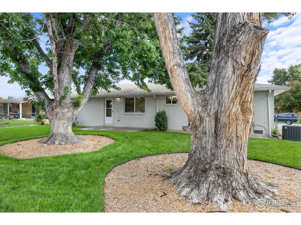 1245 Sumner Street Longmont, CO 80501 - Photo 24 of 25 a front view of a house with garden