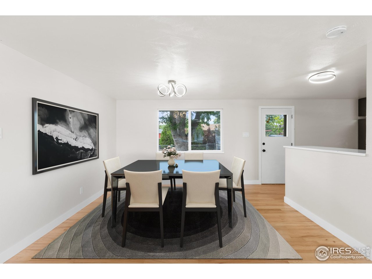 1245 Sumner Street Longmont, CO 80501 - Photo 10 of 25 a view of a dining room with furniture window and wooden floor