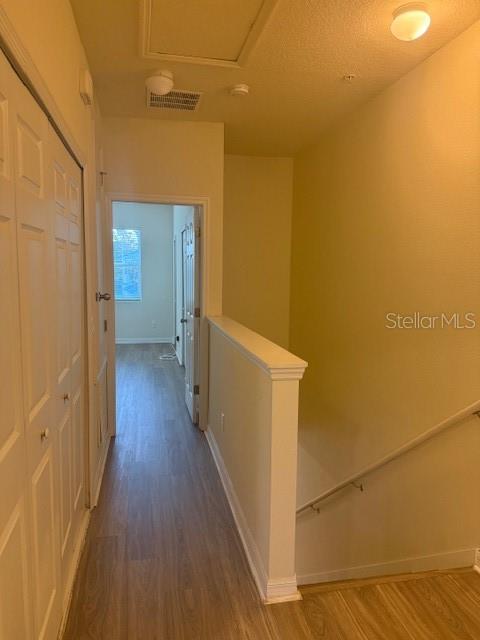 8145 Serenity Spring Drive, Unit GE Windermere, FL 34786 - Photo 11 of 31 a view of a hallway with wooden floor