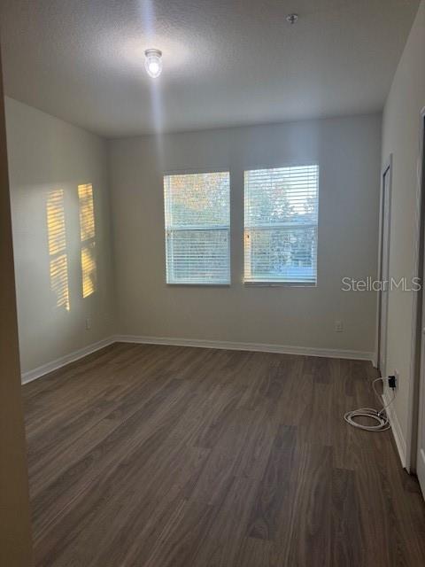8145 Serenity Spring Drive, Unit GE Windermere, FL 34786 - Photo 16 of 31 a view of an empty room with wooden floor and a window