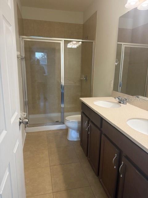 8145 Serenity Spring Drive, Unit GE Windermere, FL 34786 - Photo 18 of 31 a bathroom with a sink a toilet and shower