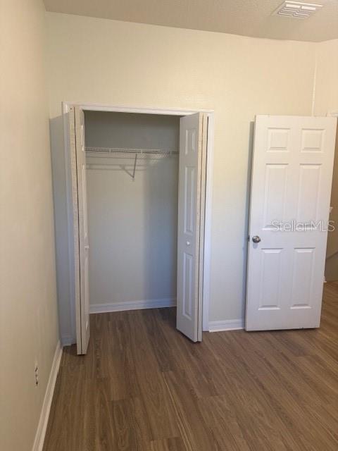 8145 Serenity Spring Drive, Unit GE Windermere, FL 34786 - Photo 22 of 31 an empty room with wooden floor and closet